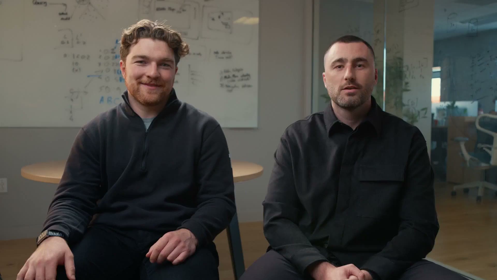 Solidroad's two founders sitting side by side in the office