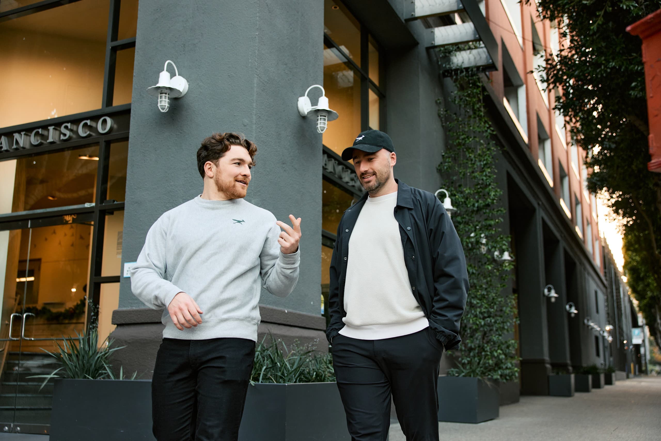 Solidroad's two founders talking as they walk down a street in San Francisco